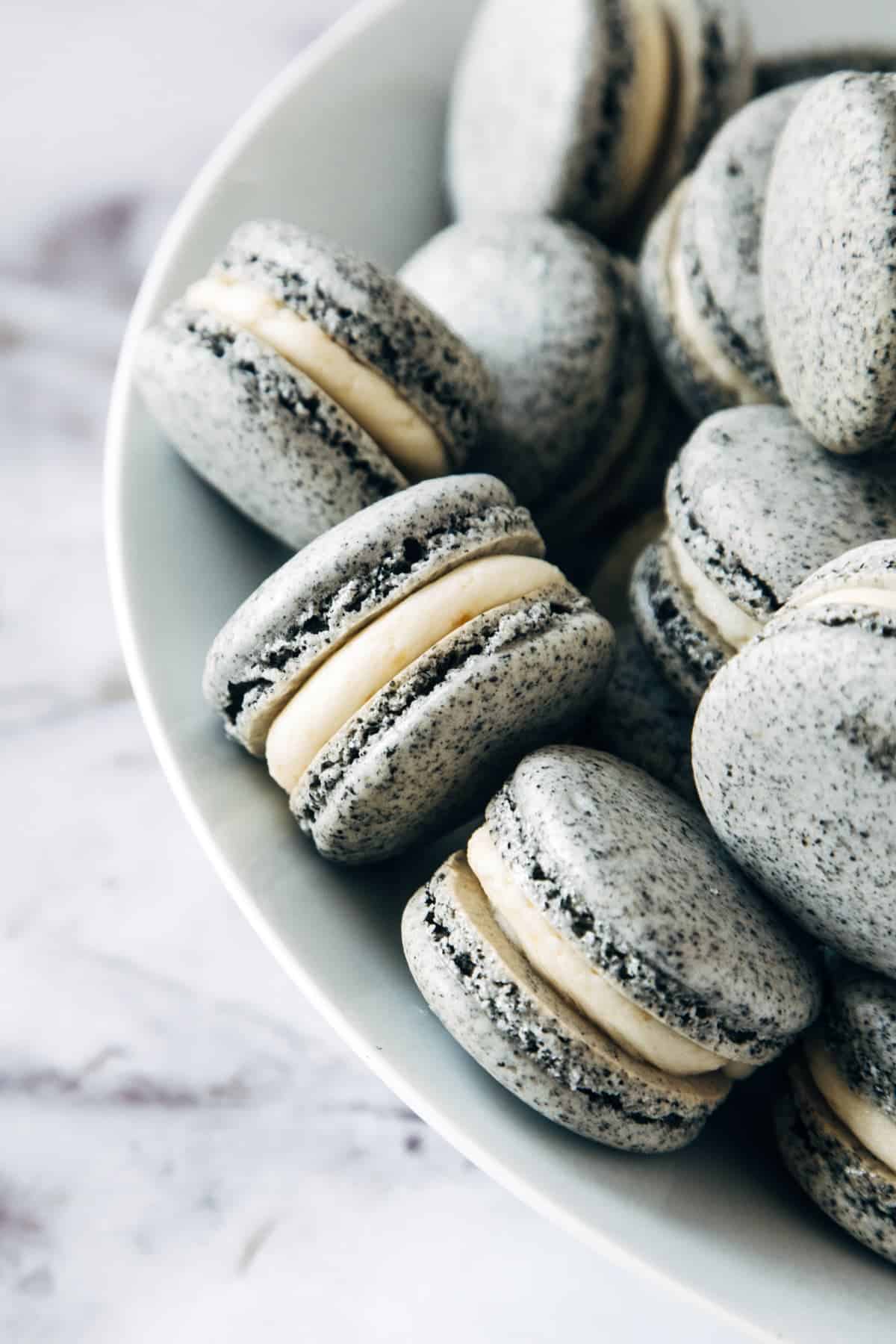 Closeup of Black Sesame & Apricot Macarons.