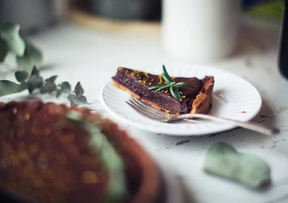 Slice of chocolate tart on a plate.