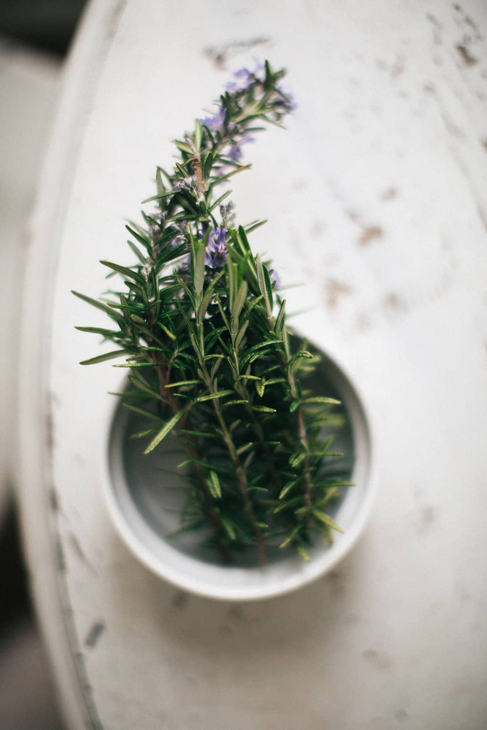 Crystallized rosemary in a bowl.