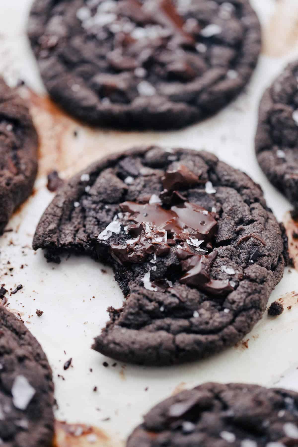 Double dark chocolate cookies with a bite taken out of the side.