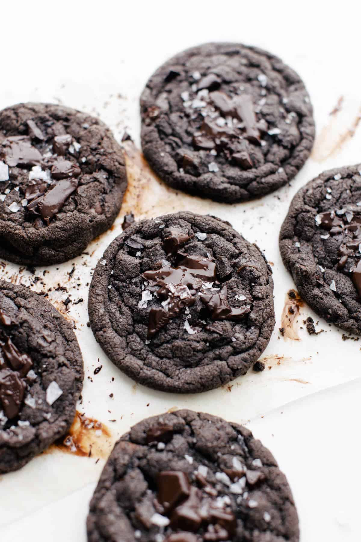 Baked chocolate cookies on parchment paper.