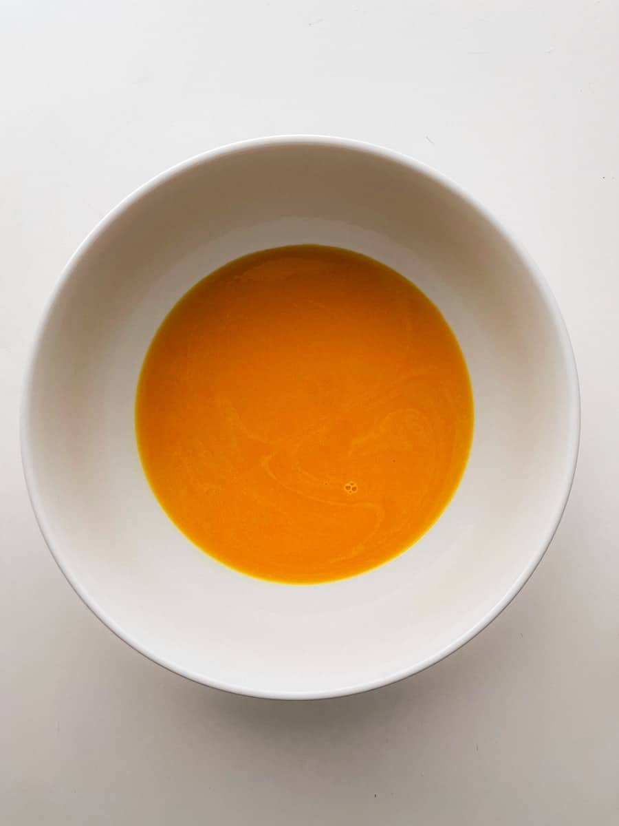 Egg yolks and sugar in a bowl.