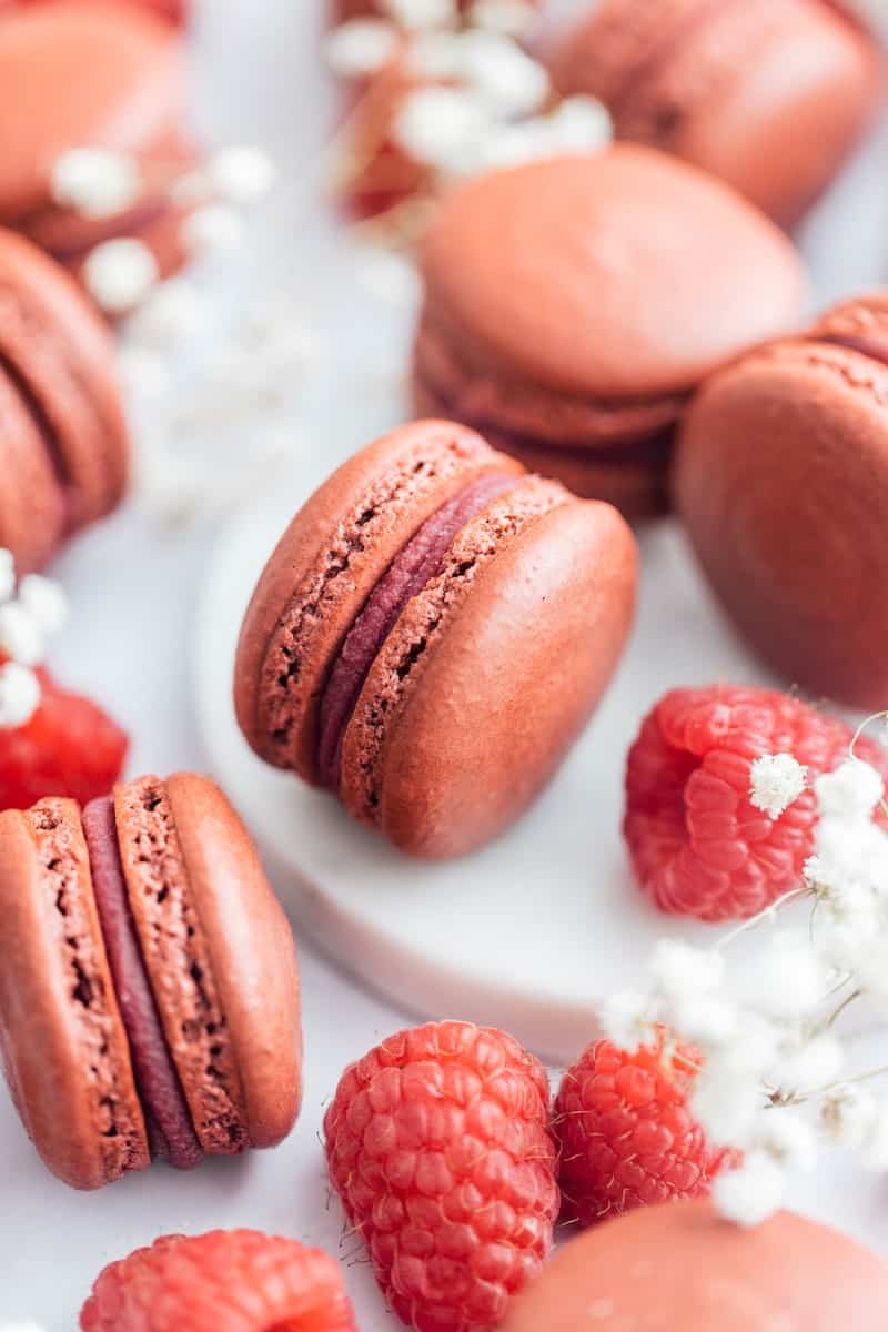 Yuzu Raspberry Macarons on counter.