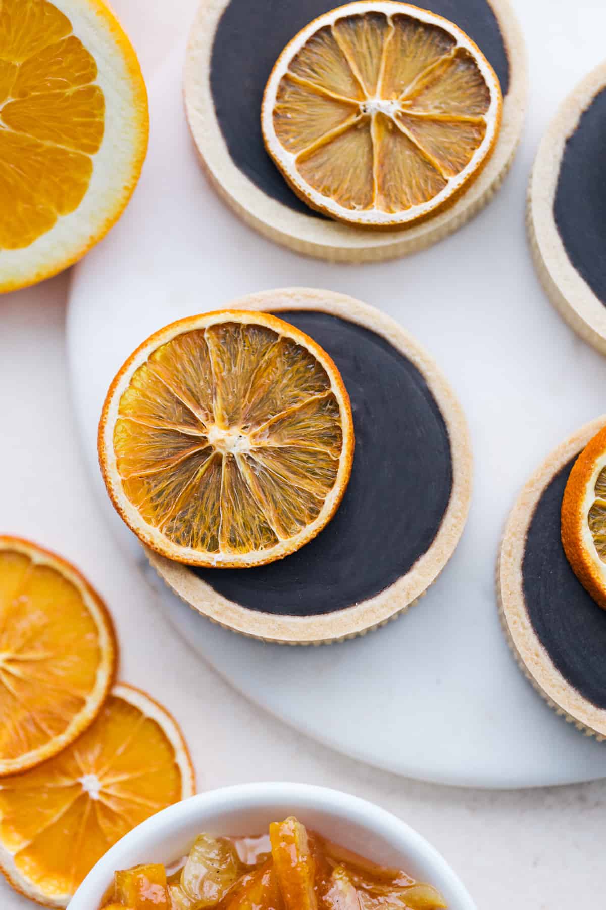 Overhead of Orange Chocolate Ganache Tartlets on a countertop.