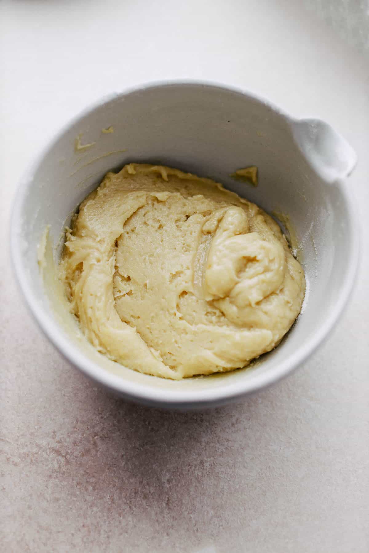 Mixing wet ingredients to make cookie dough in a bowl. 