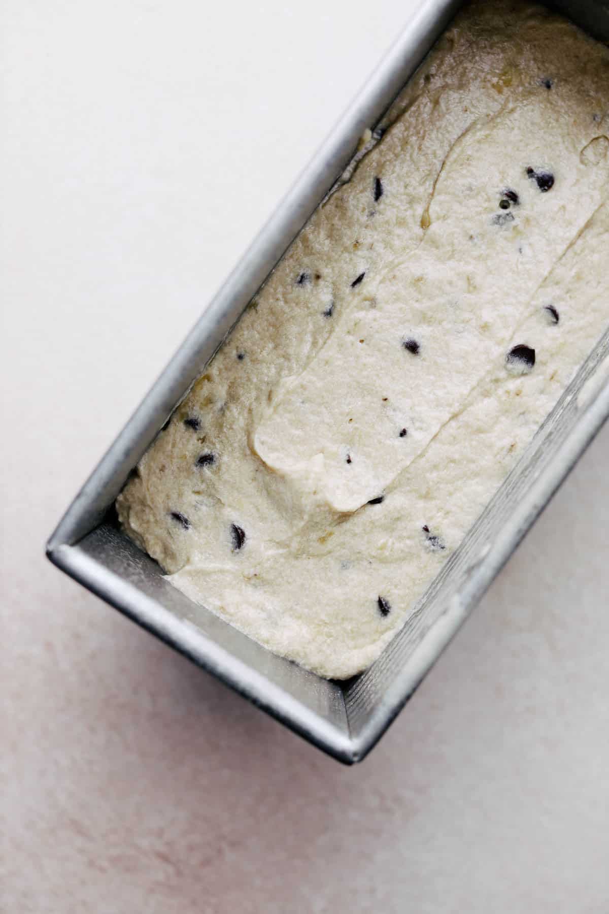 Chocolate chip banana bread batter in a loaf pan.