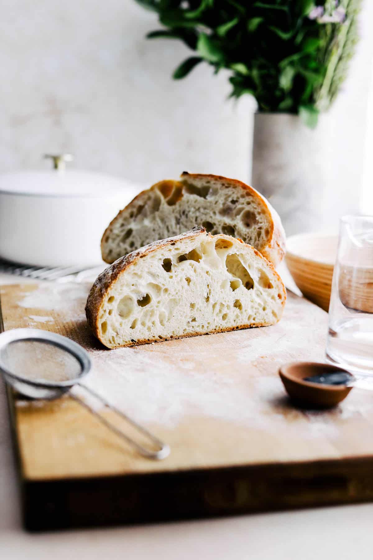 Cut open sourdough bread on a cutting board.