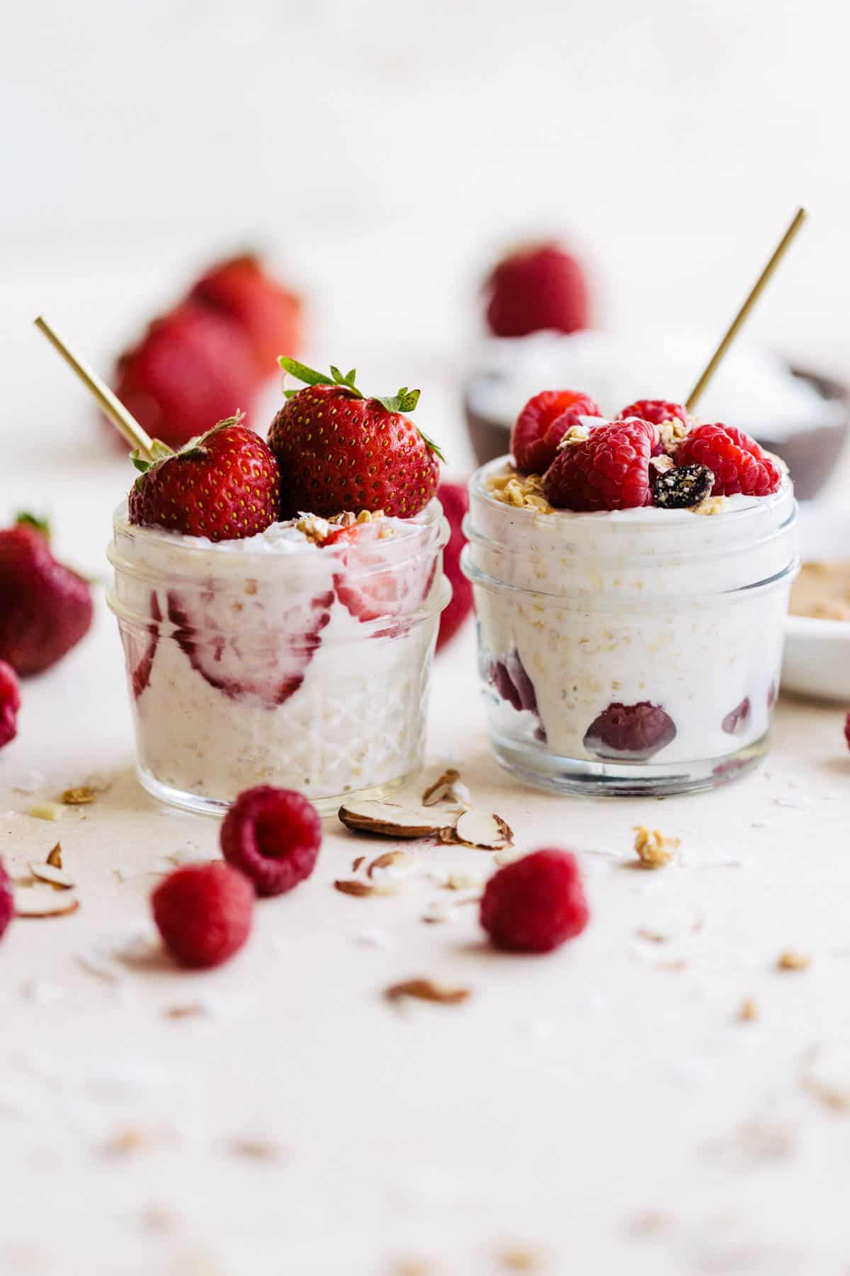 Small containers of overnight oats with coconut milk and fresh fruit with granola.