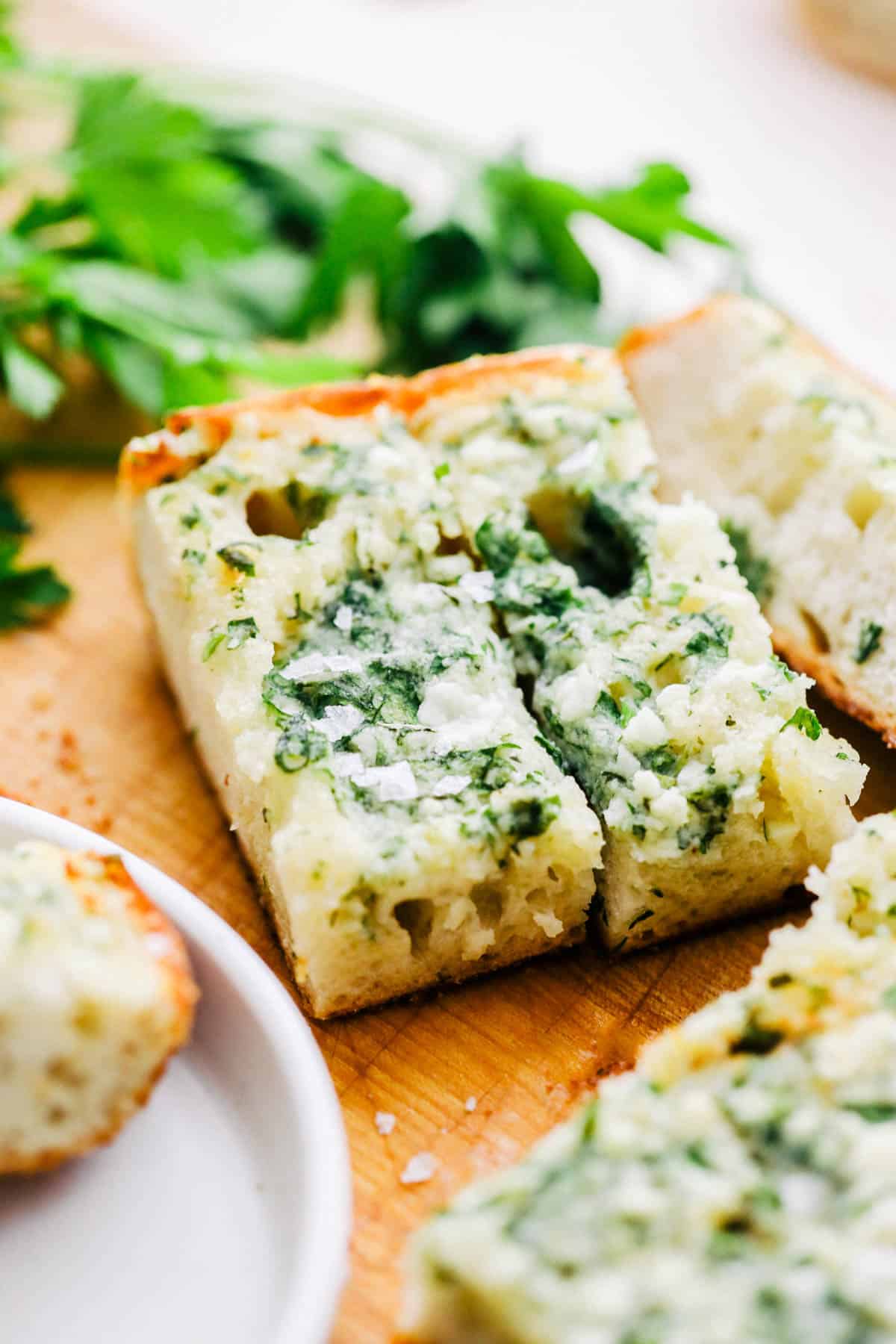 Two pieces of baked garlic bread.
