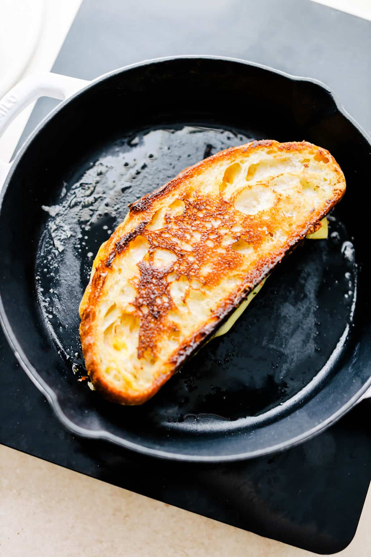 Grilled cheese sandwich in a cast iron pan.
