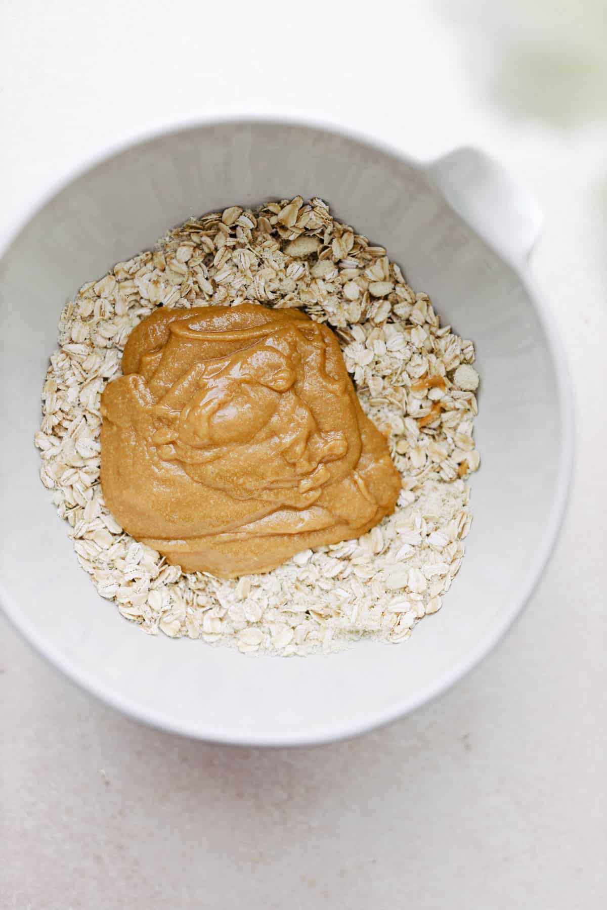 Oats and almond butter in a mixing bowl.