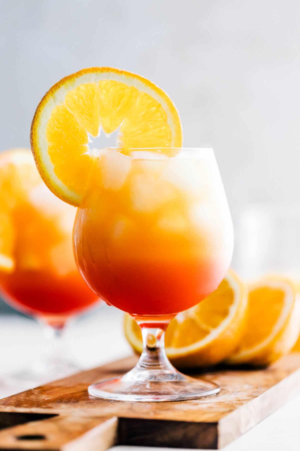 Ombre view of vodka sunrise cocktail with red base and then an orange top.
