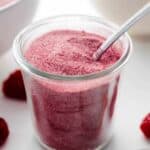 Raspberry sugar in a small, glass container.