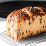 Chocolate chip brioche loaf on a cooling rack.