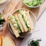 Brioche sandwich with egg salad on a cutting board.