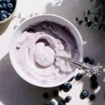Blueberry cream cheese frosting in a bowl.