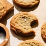 Chocolate chipless cookies on the counter with flakey sea salt.