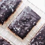 Chocolate covered rice krispie treats on a cooling rack.