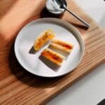 Bananas brulee thumbnail with caramelized bananas on a plate.