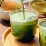 Matcha cold foam poured into a matcha drink.