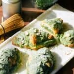 Matcha croissants on a serving board in the sun.