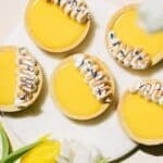 Mini lemon meringue tarts on the counter with toasted meringue.
