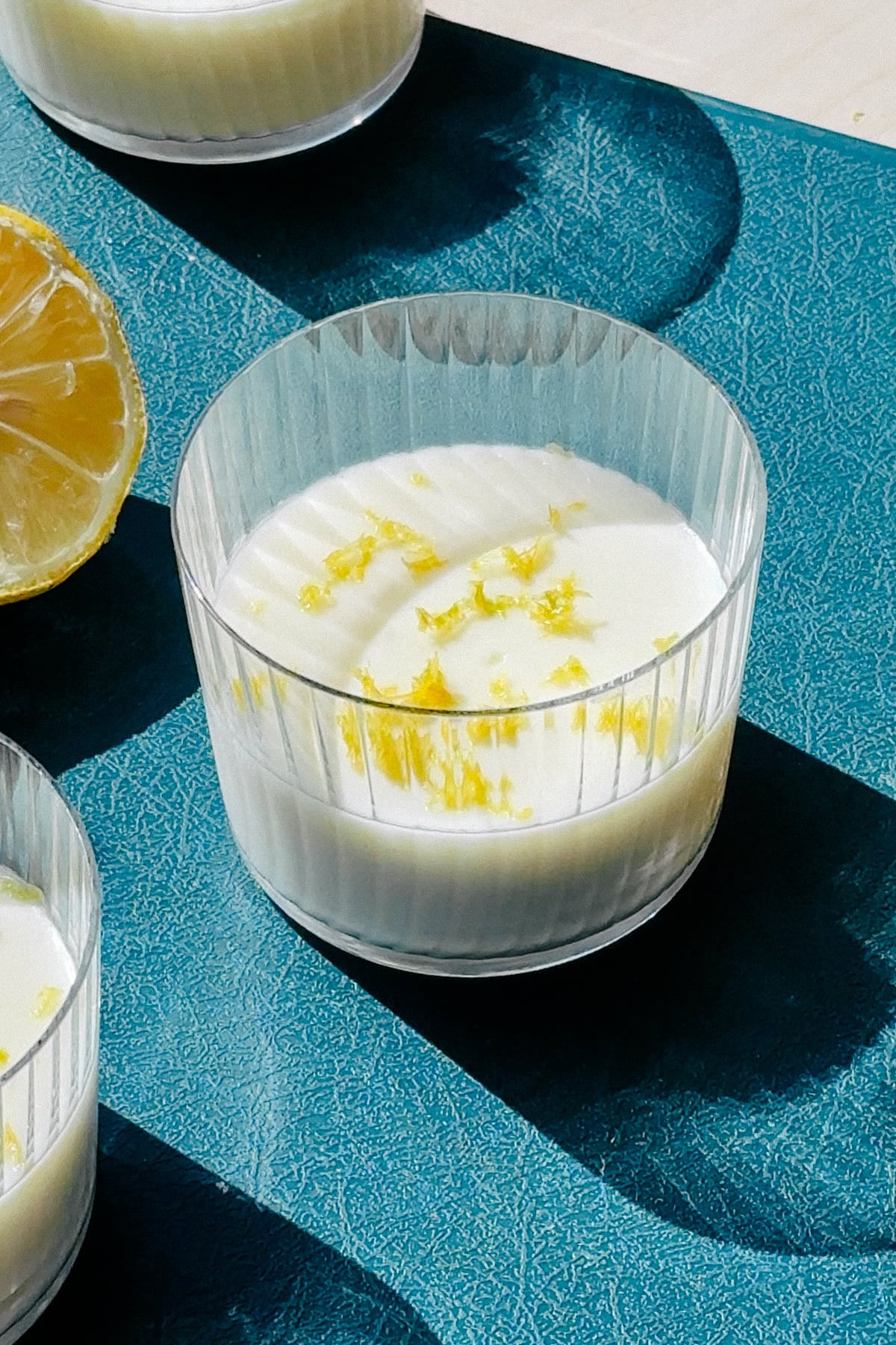 Lemon Posset in small cups on a cutting board.