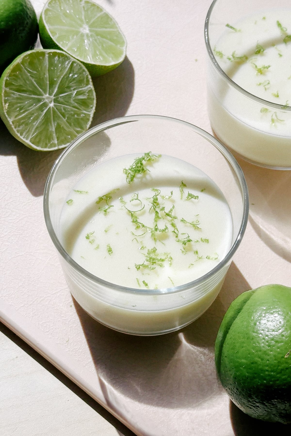 Lime Posset in small cups on a cutting board.