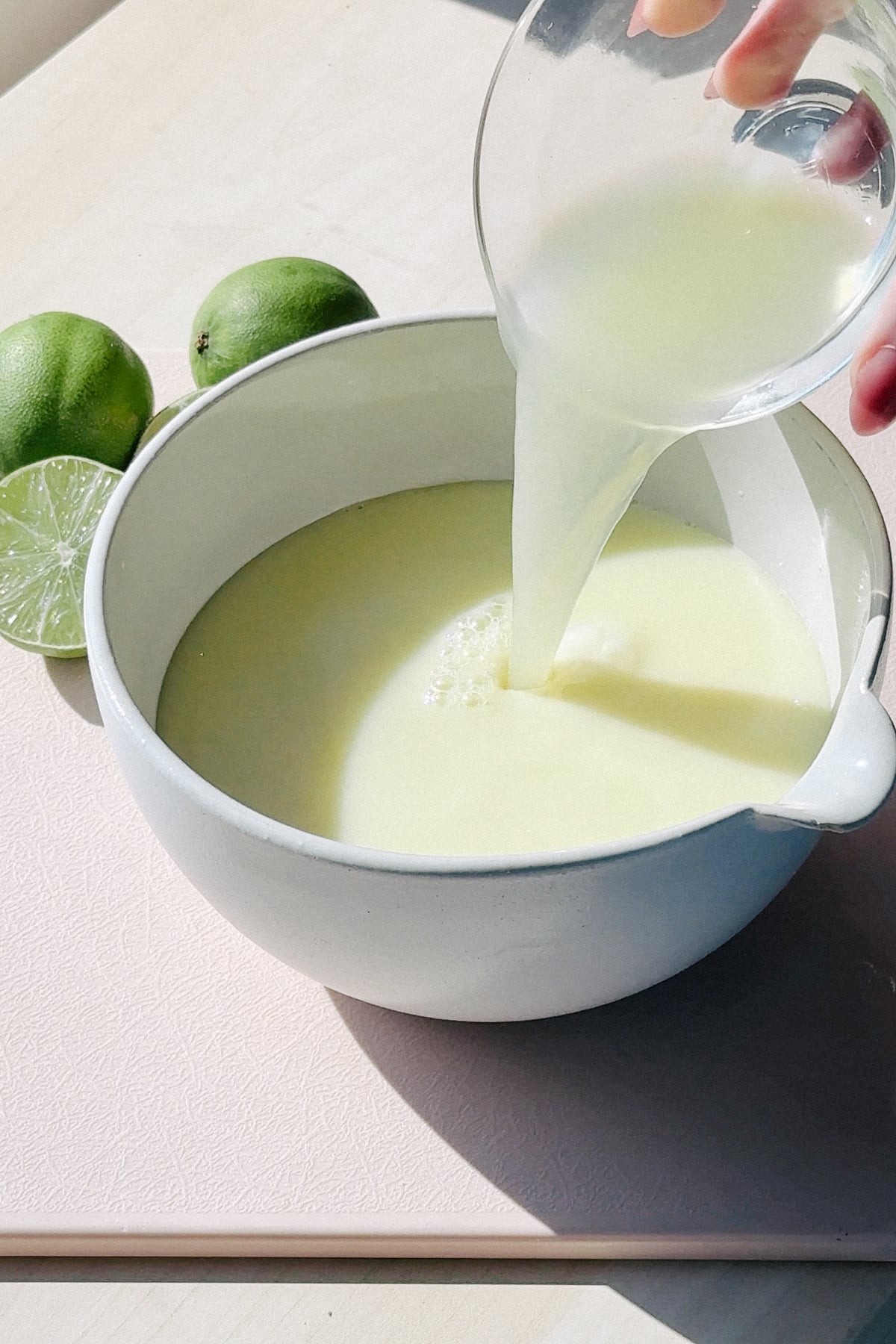 Adding lime juice into the posset base.