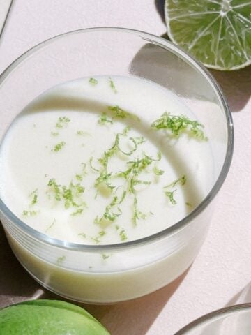 Lime Posset in small cups on a cutting board.