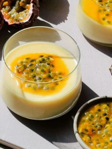 Passion Fruit Posset in small cups on a cutting board.