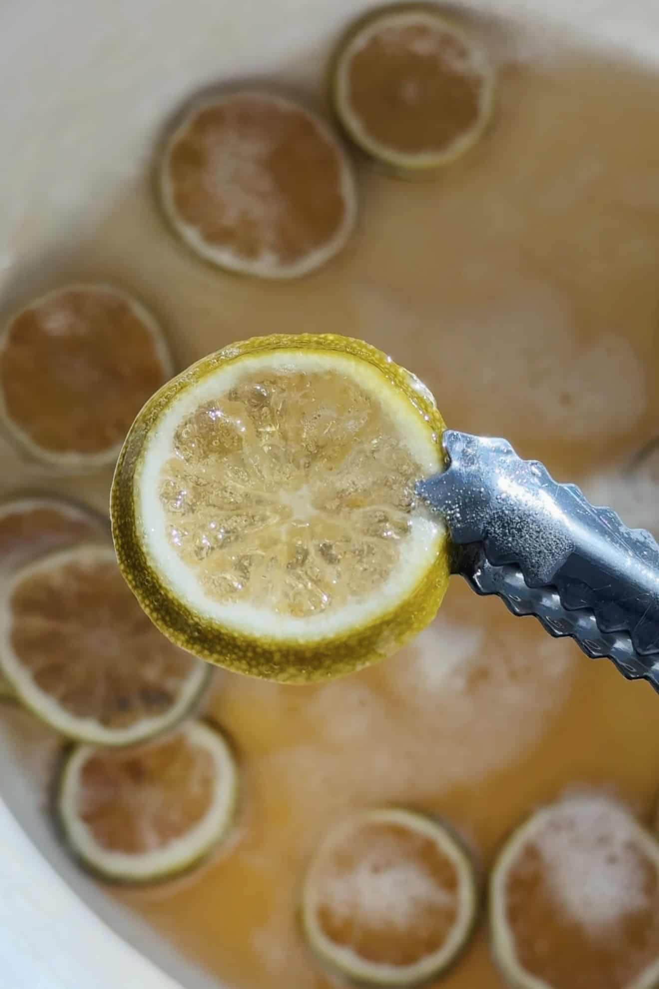 Removing candied limes from simple syrup.