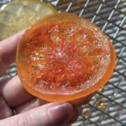 Candied grapefruit next to a cooling rack.