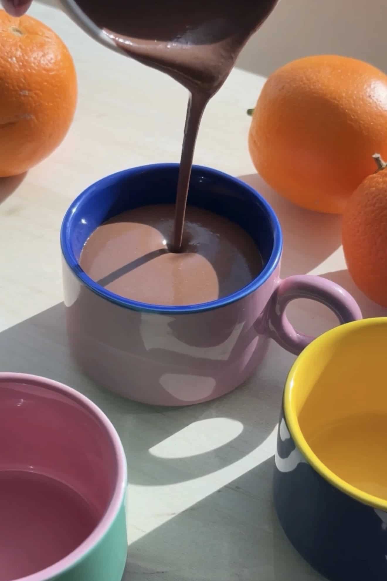Pouring parisian hot chocolate in a small mug.
