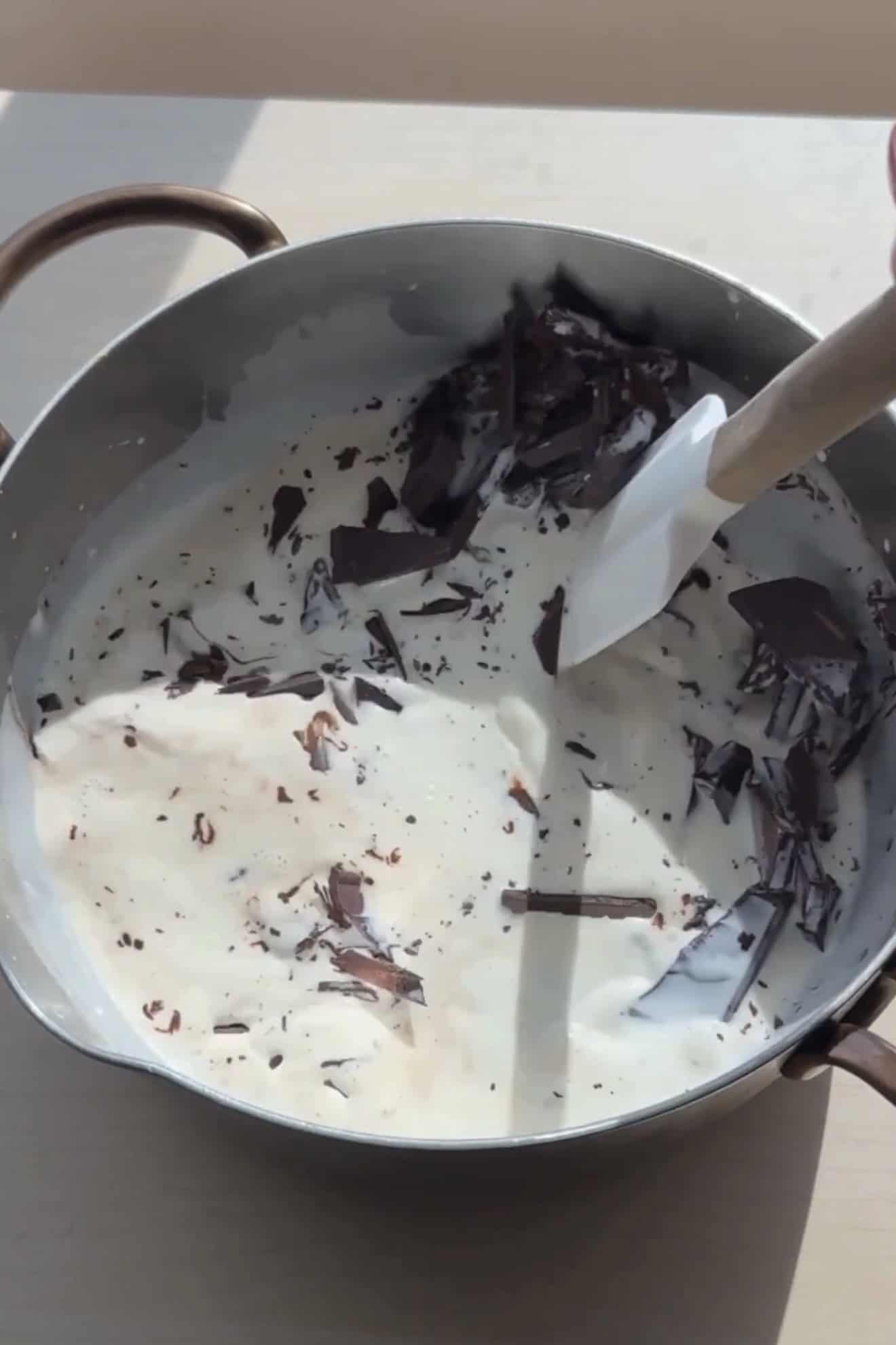 Mixing together hot chocolate ingredients in a saucepan.