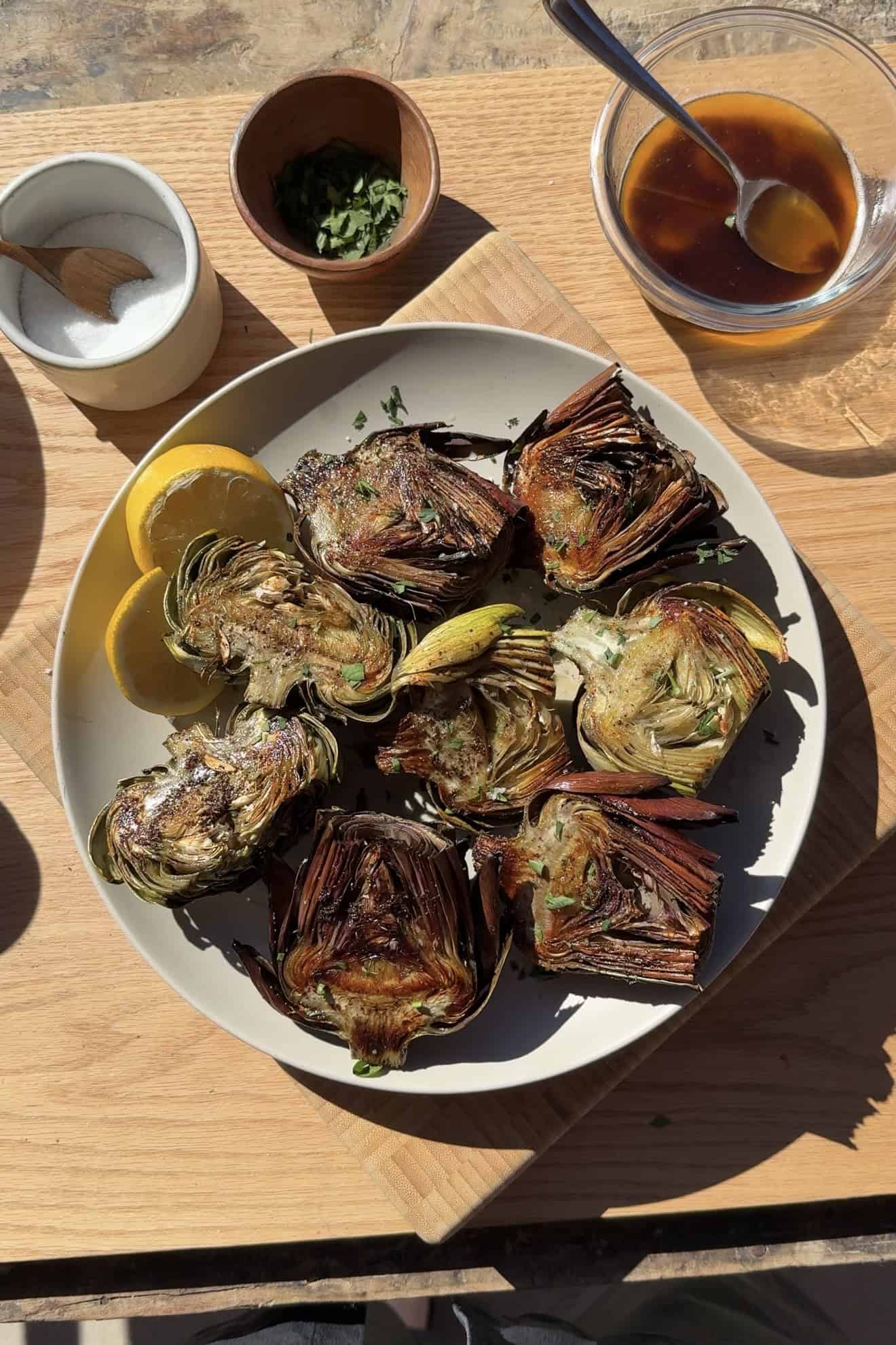 Roasted crispy artichokes on a serving platter.