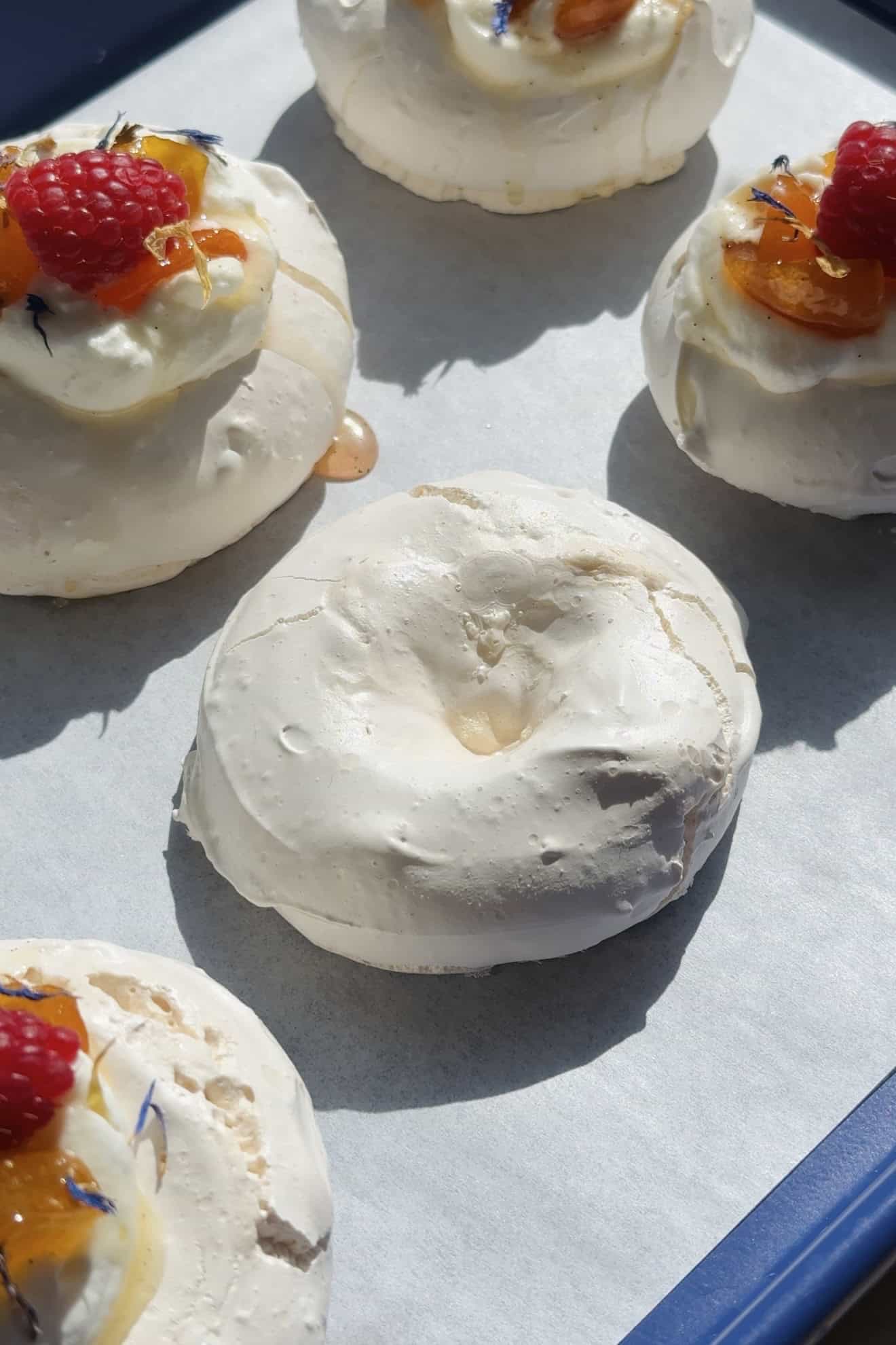 Baked pavlova on a baking sheet without anything on top.