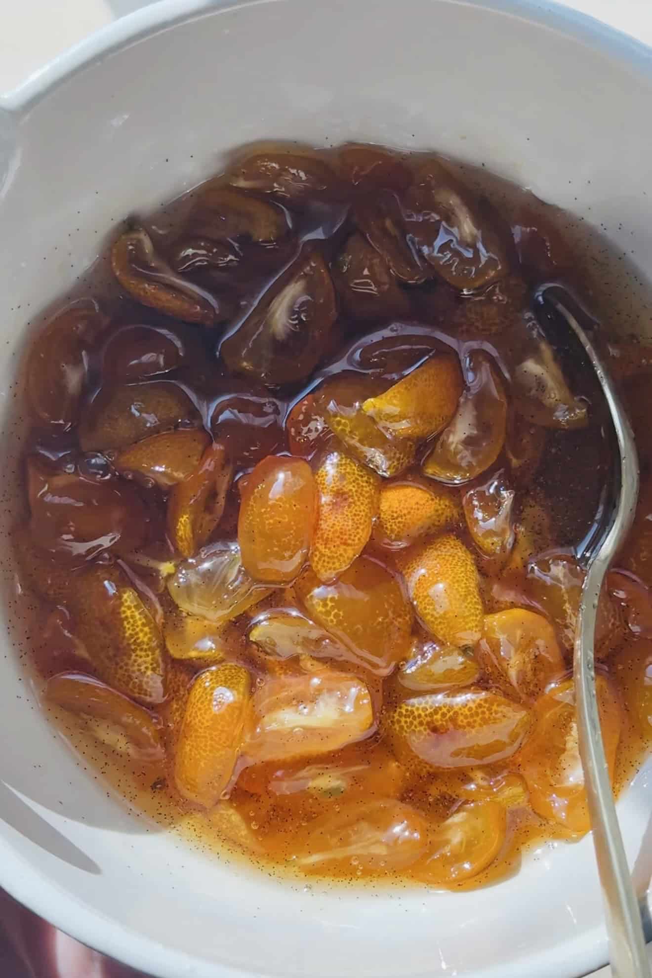Bowl of candied kumquats, with vanilla bean flecks. 
