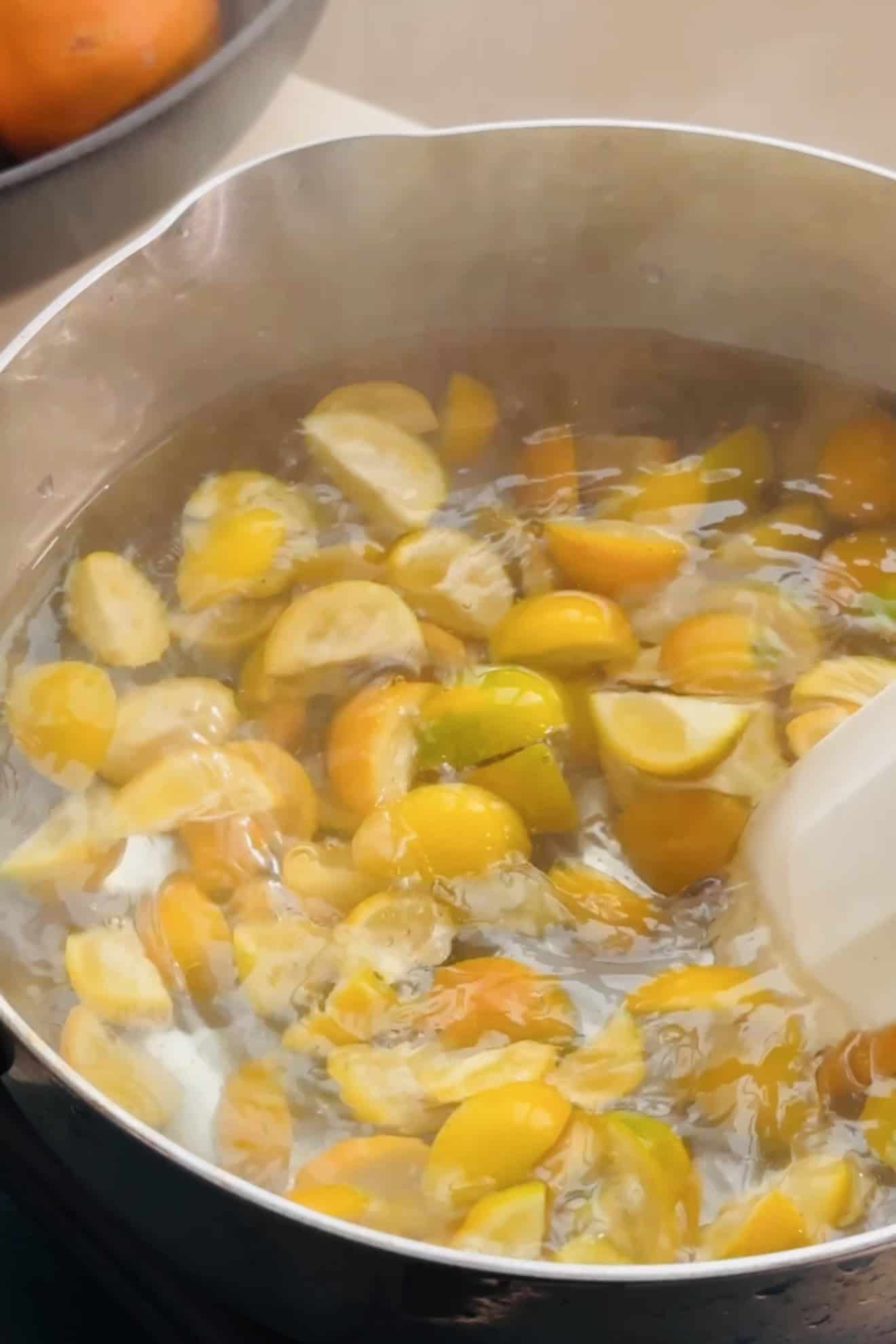 Kumquats in boiling water to be blanched.